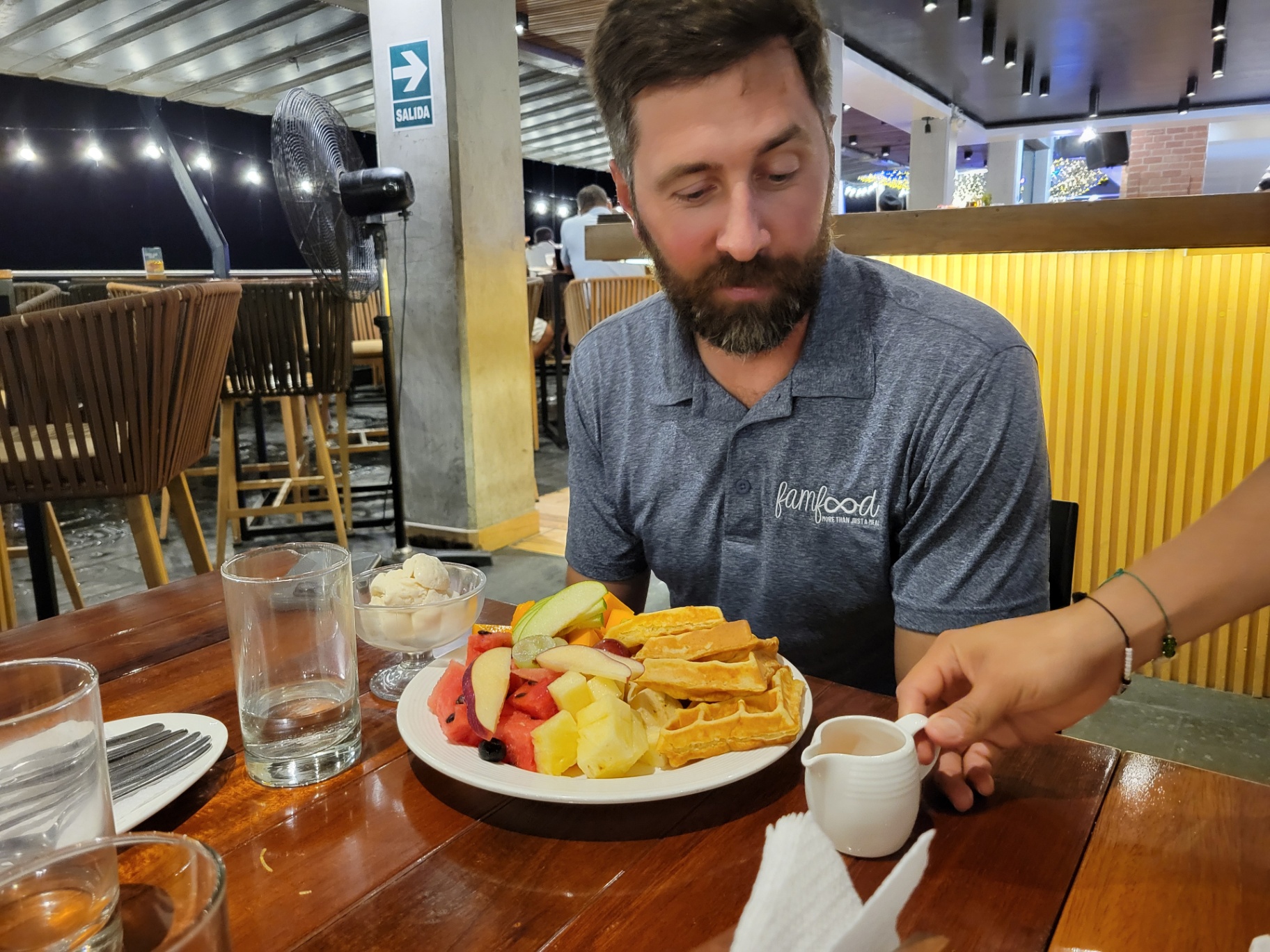 Simple breakfast plate with fruit and waffles on a wooden table