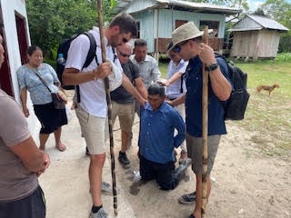 Team laying hands and praying over a kneeling local pastor